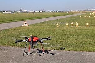 Drone from Colibrex on airport runway preparing for Glide Path measurement with airfield lights in view
